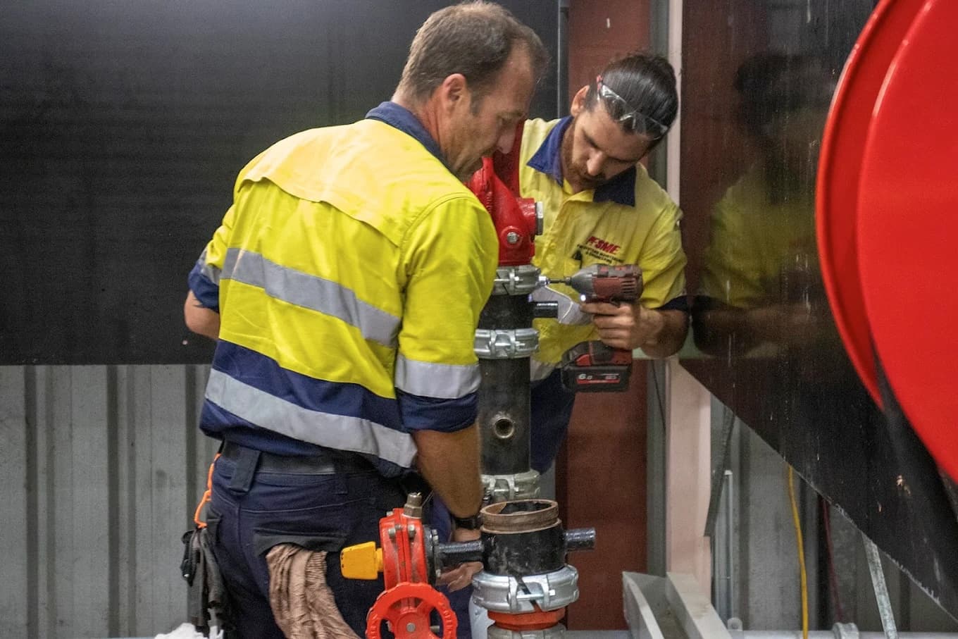FSME apprentices training in fire protection systems — hands-on sprinkler fitting and maintenance